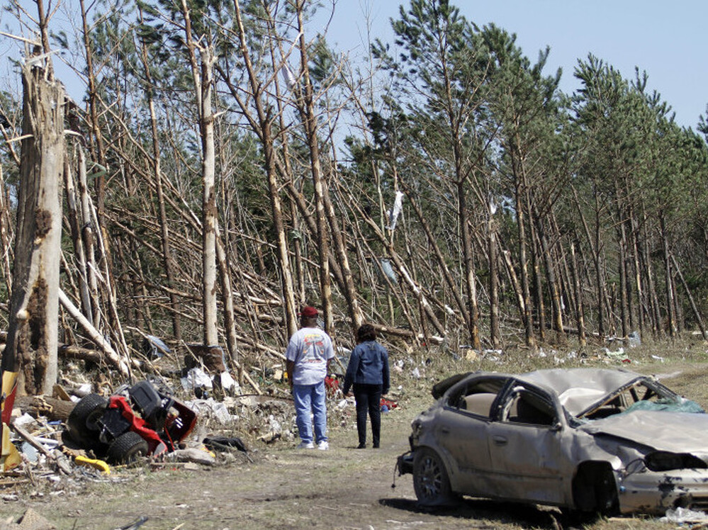 Passers-by inspect tornado damage Sunday in Askewville, N.C. Rescue crews searched for survivors in wind-blasted landscapes throughout the day Sunday and into Monday in North Carolina, the state hardest hit by a storm system that spawned dozens of tornadoes from Oklahoma to Virginia.