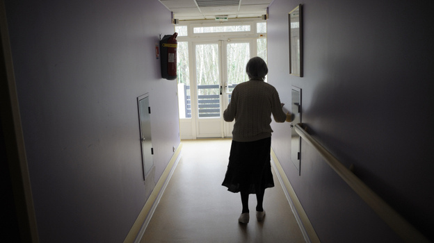A woman with Alzheimer's disease walks in a corridor at a retirement house in Angervilliers, France, last month.