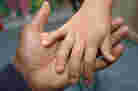 A father and child hold hands.