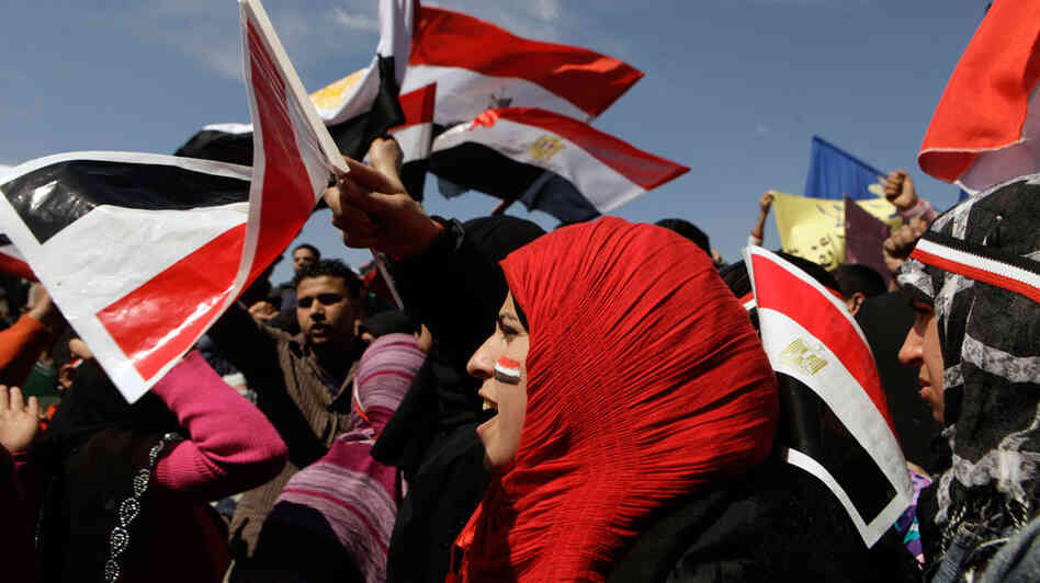 Women chant slogans and wave the Egyptian flag during a rally March 11 to support national unity of Muslims and Christians in Cairo's Tahrir Square, the focal point of the uprising that ousted Hosni Mubarak. Women chant slogans and wave the Egyptian flag during a rally March 11 to support national unity of Muslims and Christians in Cairo's Tahrir Square, the focal point of the uprising that ousted Hosni Mubarak.
