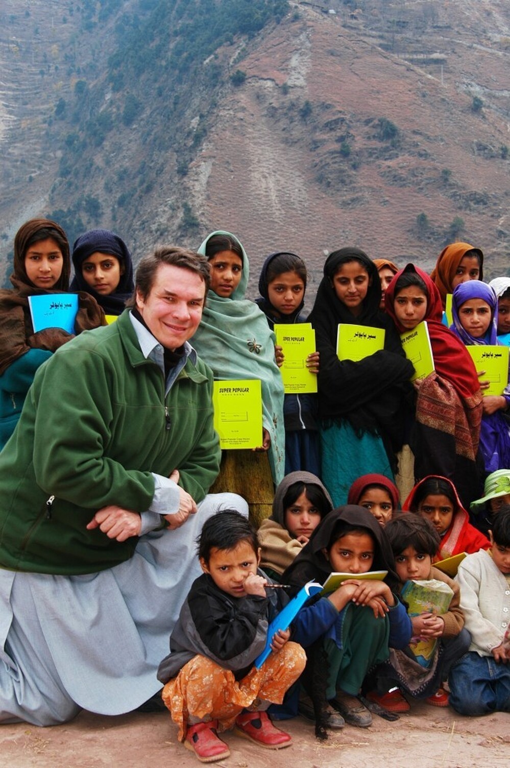 Greg Mortenson, the author of Three Cups of Tea and Stone Into Schools, poses with Nowseri schoolchildren in Azad Kashmir, Pakistan. Greg Mortenson, the author of Three Cups of Tea and Stone Into Schools, poses with Nowseri schoolchildren in Azad Kashmir, Pakistan.