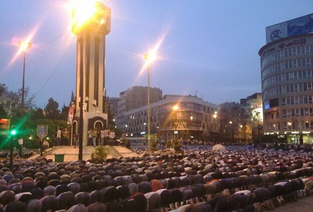 A cell phone photo taken Monday shows Syrians kneeling in prayer in Clock Square in the city of Homs. A day later, security forces fired tear gas and live ammunition at hundreds of anti-government protesters there.