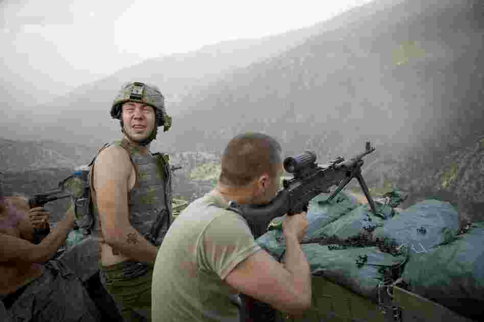 Tim Hetherington and Sebastian Junger jointly directed, filmed and produced the film Restrepo from June 2007 to January 2010. In this image, Specialist Misha Pemble-Belkin (left) and fellow soldiers from Battle Company, 173rd US Airborne, are seen during a firefight at Outpost Restrepo during combat in Afghanistan's Korengal Valley.
