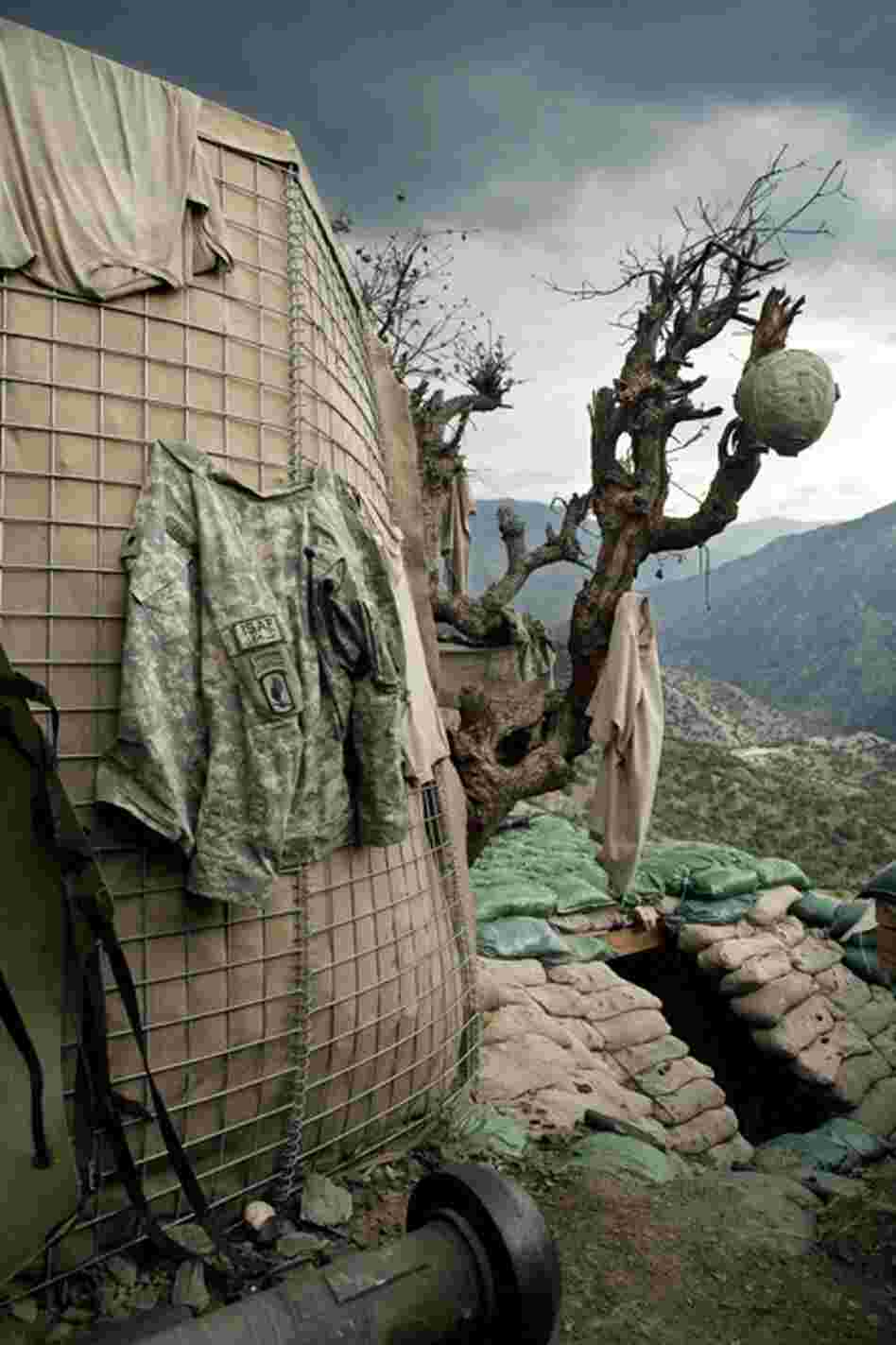 Clothes hang out to dry as rain clouds gather over the Restrepo bunker high up on the edges of the Korengal Valley.