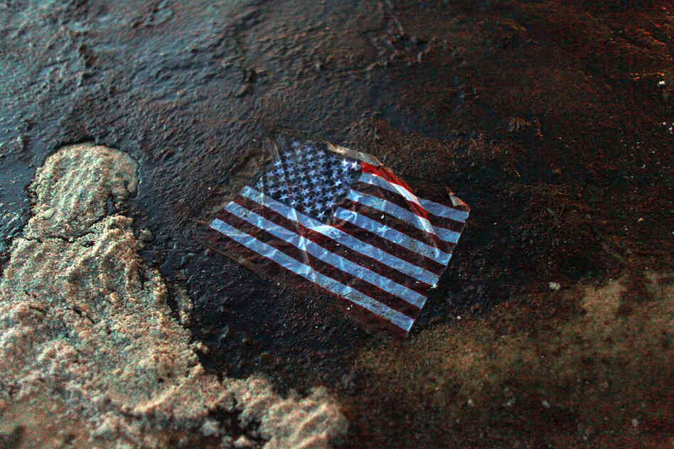 On April 20, 2010, the Deepwater Horizon oil drilling rig exploded in the Gulf of Mexico, setting off the nation's worst oil spill. An American flag lies in a slick of oil that washed ashore in Gulf Shores, Ala., July 4. 