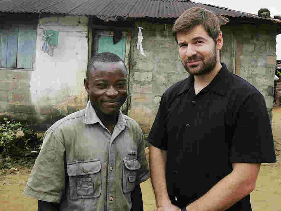 Photojournalist Chris Hondros poses with a a former Liberian government soldier in Monrovia, Liberia, in 2005.