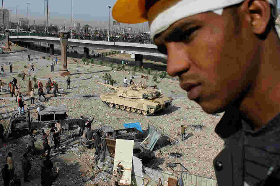 An Egyptian anti-government protester stands on a balcony over the front line between anti- and pro-Mubarak factions on the edge of Cairo's Tahrir Square on Feb. 3.