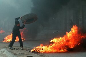 In the late 1990s, both Marinovich and Silva traveled to the Middle East to photograph ongoing clashes in the region. Silva captured this young Palestinian boy throwing a tire in the West Bank town of A-Ram in March 1997.