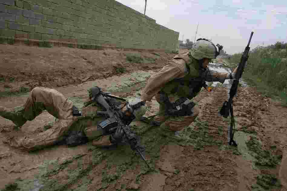 One of Silva's most well-known photographs, taken in Iraq, shows Sgt. Jesse E. Leach dragging Lance Cpl. Juan Valdez to safety moments after Valdez was shot by a sniper during a joint patrol with the Iraqi army in Karmah, Anbar province. Valdez survived. 