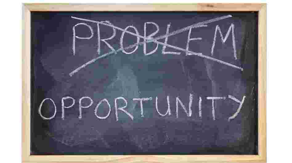 The word "problem" is crossed out on a blackboard and replaced with the word opportunity. The word "problem" is crossed out on a blackboard and replaced with the word opportunity.