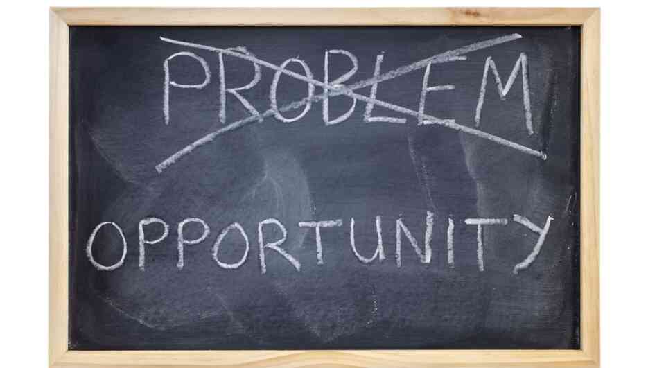 The word "problem" is crossed out on a blackboard and replaced with the word opportunity. The word "problem" is crossed out on a blackboard and replaced with the word opportunity.