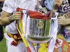 Real Madrid's Sergio Ramos, left, had a better grip (and help from teammate Iker Casillas) on the trophy earlier in the evening Wednesday. Real Madrid's Sergio Ramos, left, had a better grip (and help from teammate Iker Casillas) on the trophy earlier in the evening Wednesday.