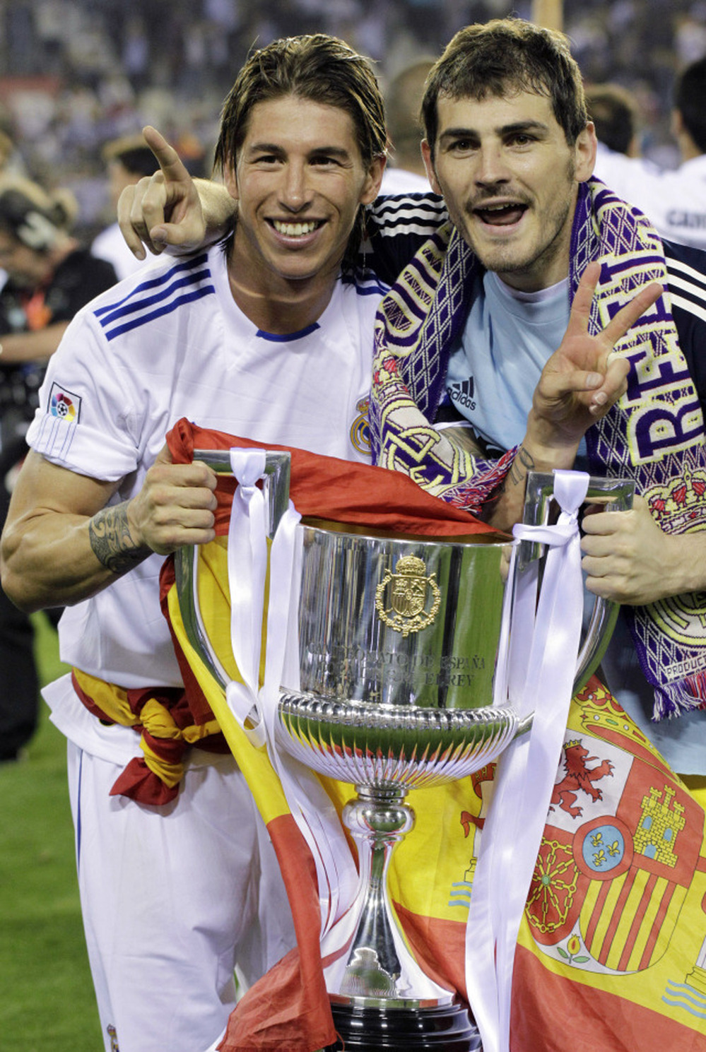 Real Madrid's Sergio Ramos, left, had a better grip (and help from teammate Iker Casillas) on the trophy earlier in the evening Wednesday.
