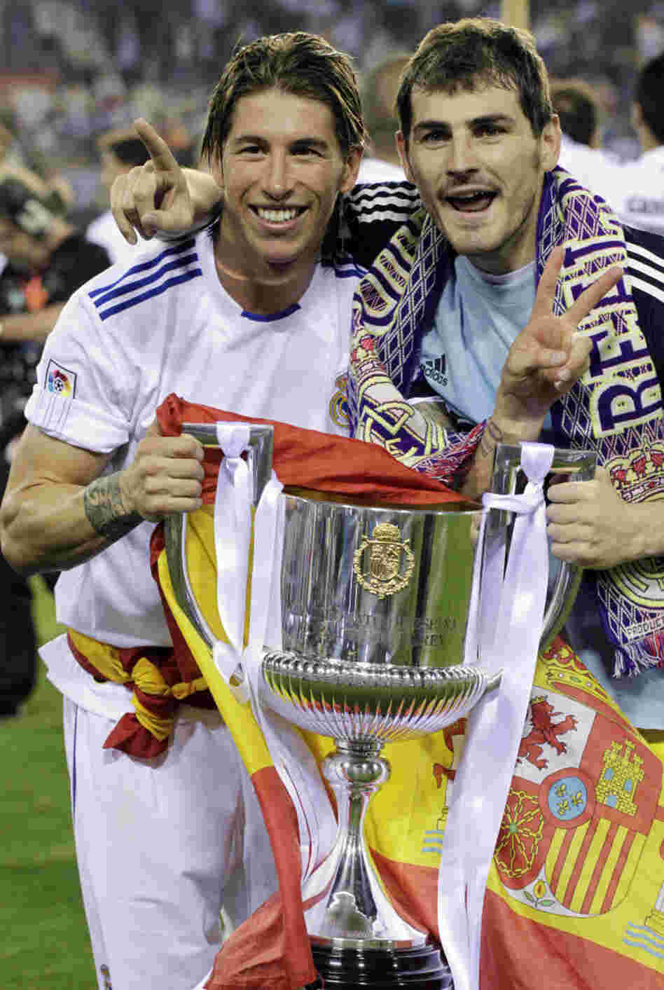 Real Madrid's Sergio Ramos, left, had a better grip (and help from teammate Iker Casillas) on the trophy earlier in the evening Wednesday.