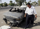 Sept. 20, 2007, file photo: An Iraqi traffic policeman inspects a car destroyed during the firefight four days earlier in Baghdad's al-Nisoor Square. Sept. 20, 2007, file photo: An Iraqi traffic policeman inspects a car destroyed during the firefight four days earlier in Baghdad's al-Nisoor Square.
