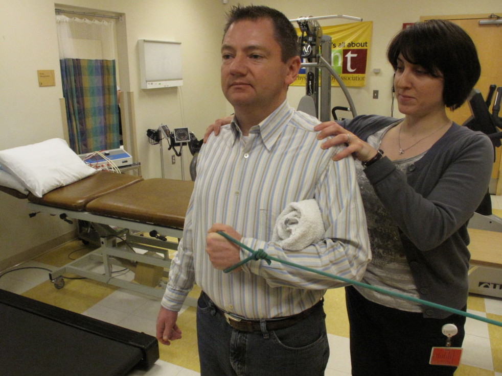 Orthopedist Popi Gianakouras helps 45-year-old Bob Rothaker with physical therapy to treat his sore shoulder.