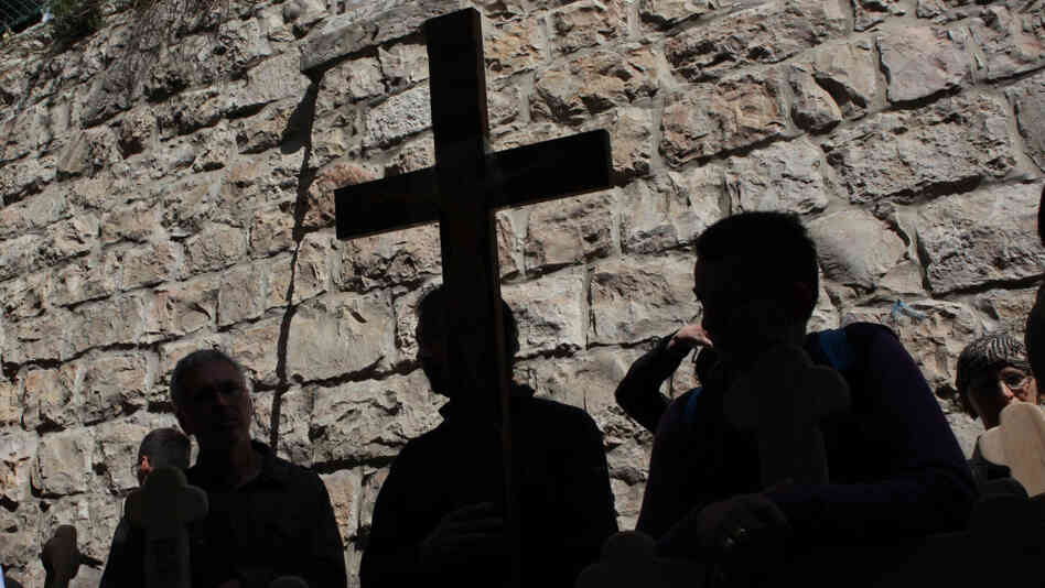 Christian pilgrims carried wooden crosses along the Via Dolorosa during the Good Friday procession in Jerusalem's old city today (April 22, 2011).