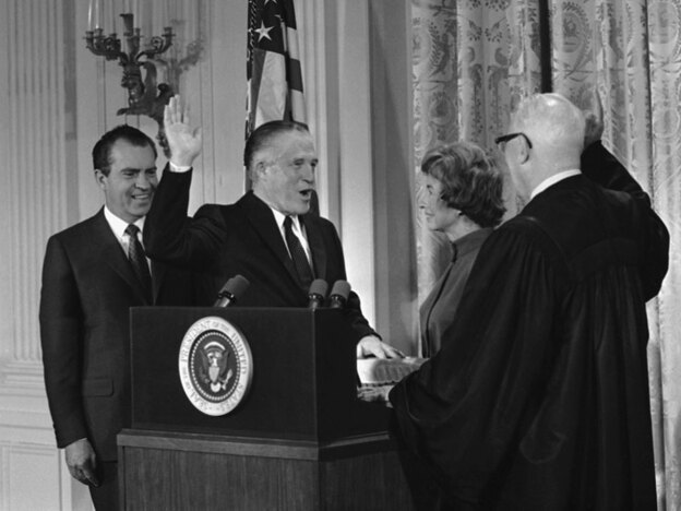 George Romney is sworn in as  secretary of Housing and Urban Development in 1969 at the White House. The oath was administered by Chief Justice Earl Warren and attended by Romney's wife and President Nixon.