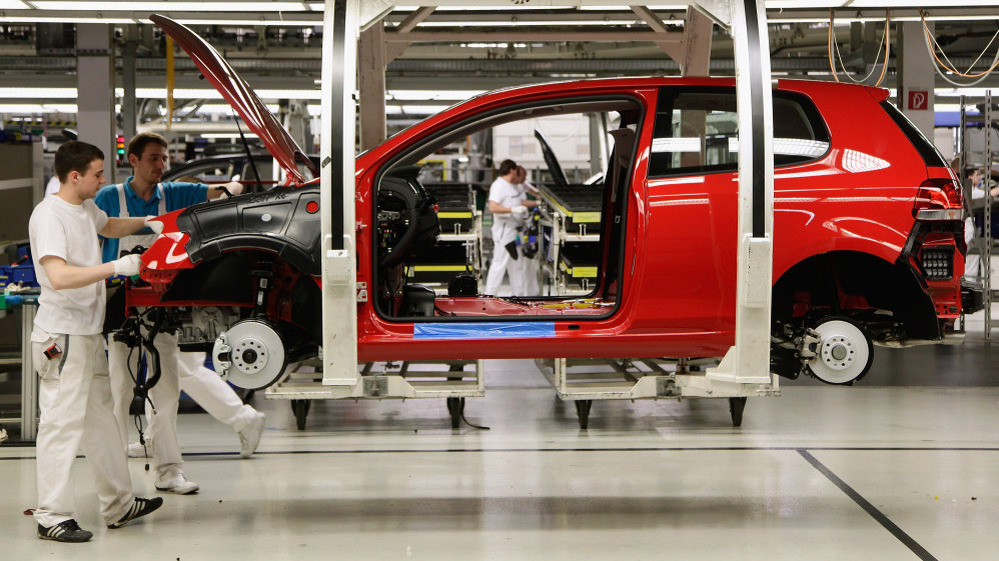 Workers assemble Volkswagen Golf 6 cars at the Volkswagen factory in Wolfsburg, Germany. Volkswagen and other German automakers are among those driving Germany's economic boom.