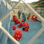 Suspected Taliban and al-Qaida detainees sit in a holding area at Camp X-Ray at Guantanamo Bay, Cuba, during in-processing to the temporary detention facility.