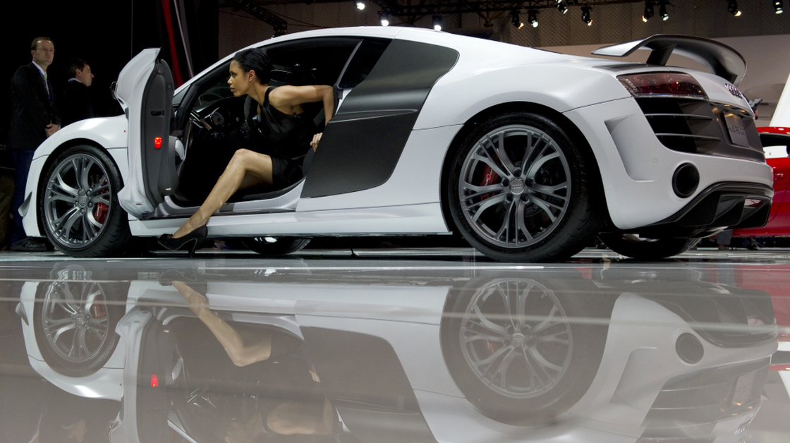 A model climbs out of an Audi during the New York International Auto Show.