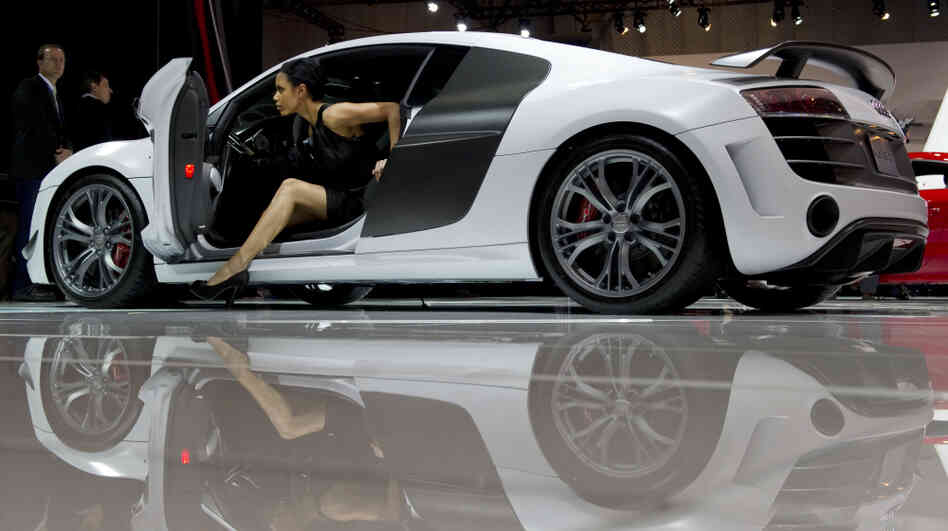 A model climbs out of an Audi during the New York International Auto Show.
