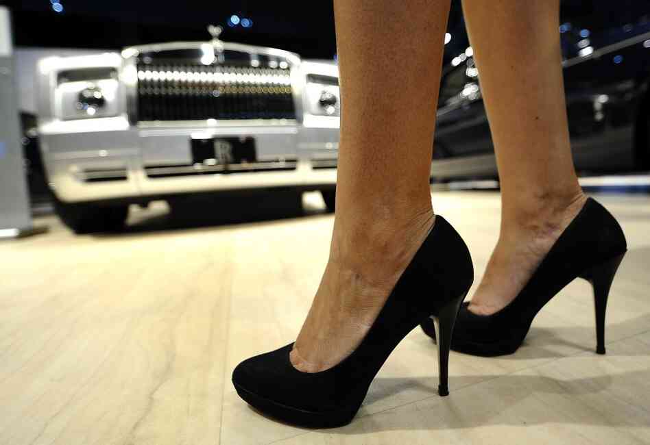 A model stands with the Rolls-Royce Phantom Drophead Coupe at the New York International Auto Show.