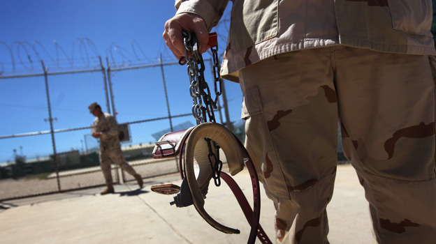 A U.S. military guard carries shackles in preparation for moving a detainee at the U.S. detention center in Guantanamo Bay, Cuba.