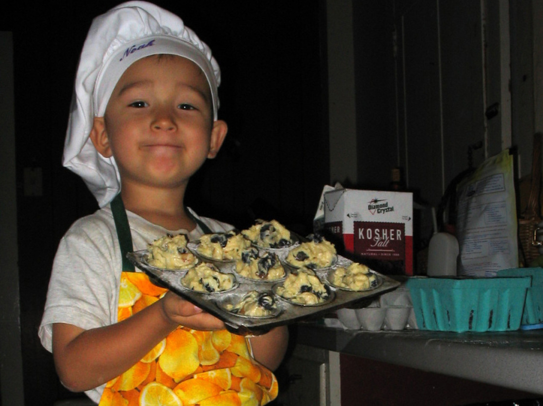Noah holds an oven-ready pan of Big-Top Blueberry Muffin batter (recipe below).