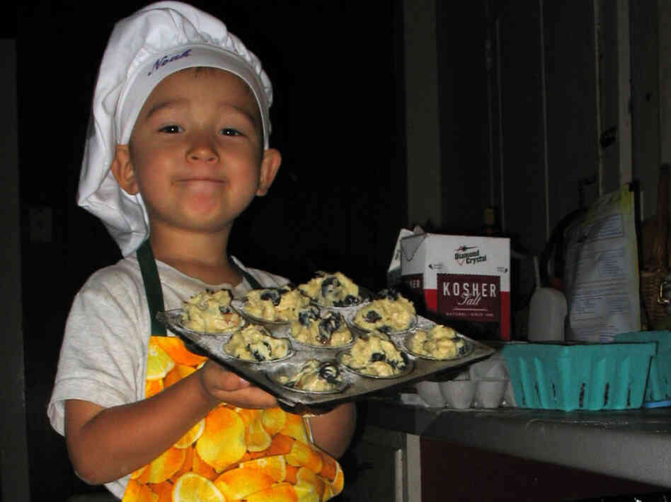 Noah holds an oven-ready pan of Big-Top Blueberry Muffin batter (recipe below).