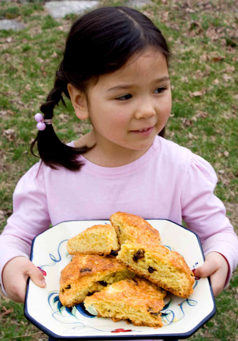 Zoe carries a platter of moist, tangy Cranberry-Orange Scones.
