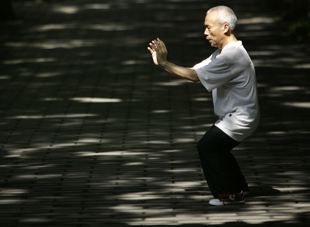 A man performs tai chi for his morning exercise in Beijing, China.