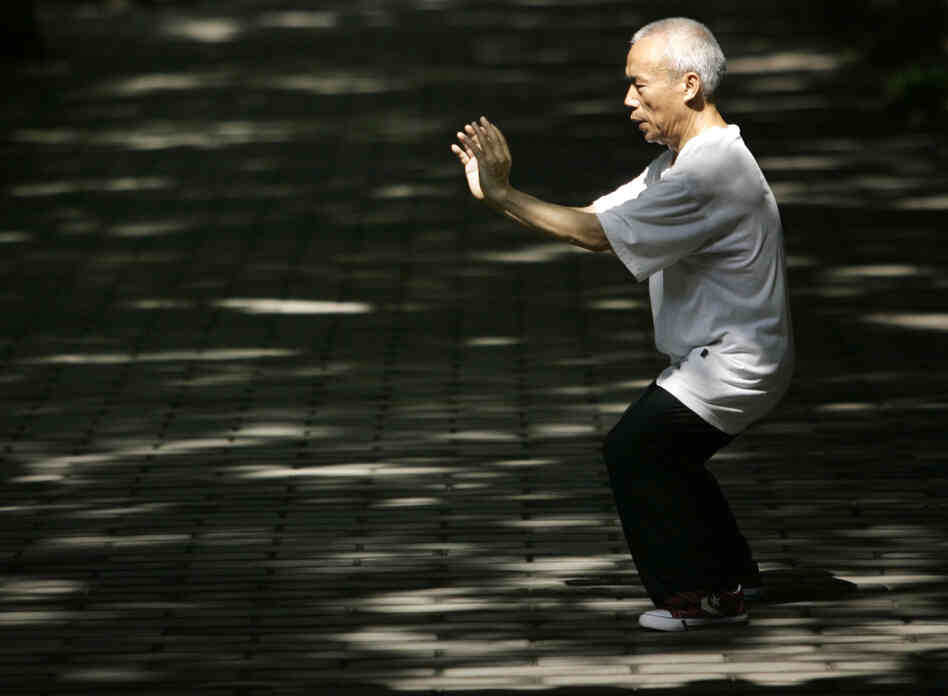 A man performs tai chi for his morning exercise in Beijing, China.