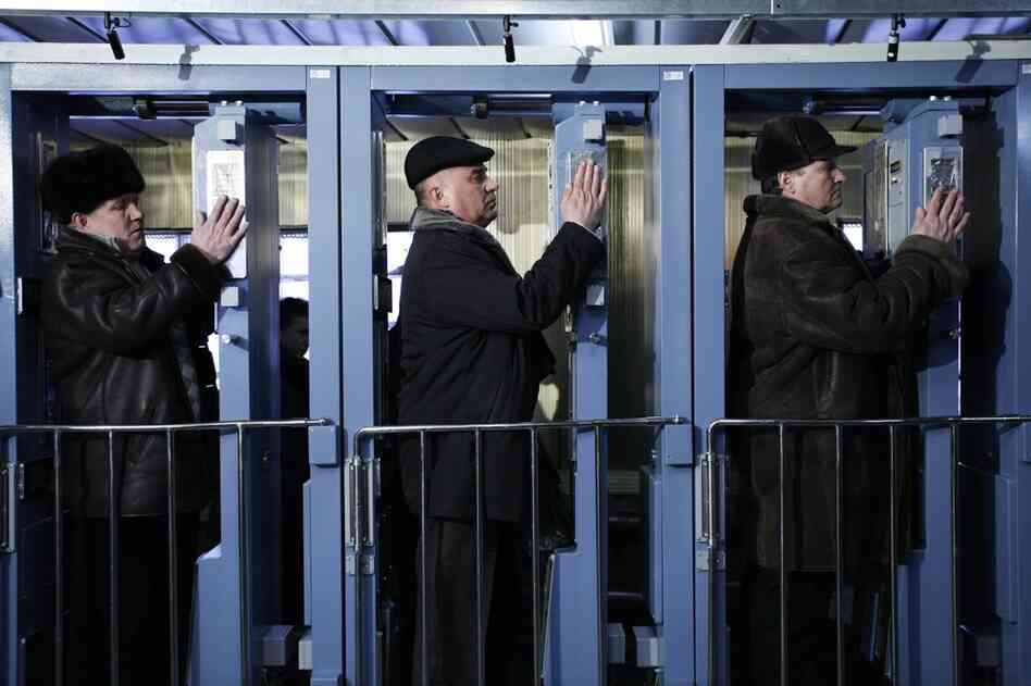 Workers at the Chernobyl plant check their hands and feet for radioactive contamination at the end of the day before boarding the train home in 2009. 