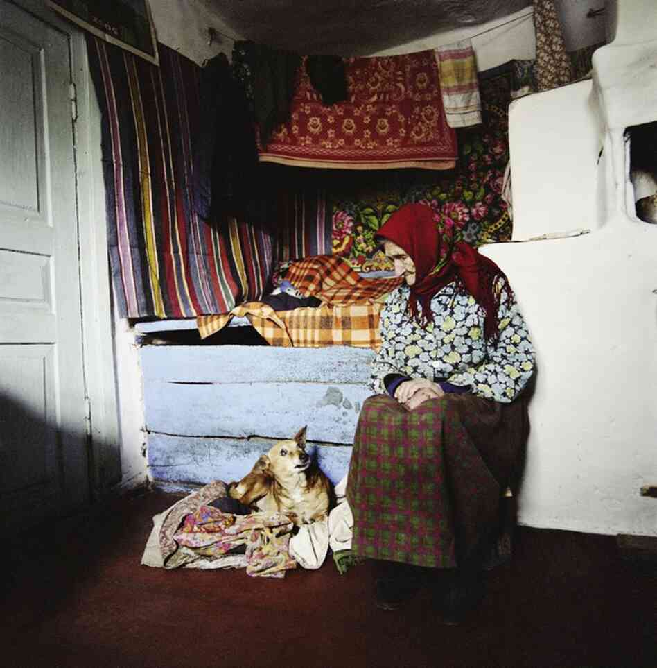 Zinayida Trofimivna Huzienko, 93, talks to her dog inside her home in the village of Ilintsi in 2006. She lives illegally inside the exclusion zone around Chernobyl. Scientists say the area around the plant will not be safe for human habitation for up to 900 years. 