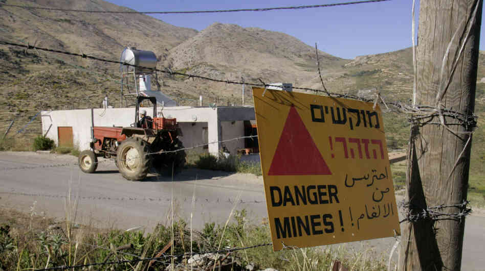 An Israeli man rides a tractor in the village of Majdal Shams in the Golan Heights, near the Israeli-Syrian border on June 1, 2007. Some worry that political unrest in Syria could threaten peace in the area. An Israeli man rides a tractor in the village of Majdal Shams in the Golan Heights, near the Israeli-Syrian border on June 1, 2007. Some worry that political unrest in Syria could threaten peace in the area.