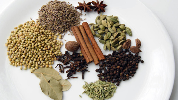 The spices of garam masala can include (clockwise from top left): cumin, star anise, cardamom seeds, black cardamom, black peppercorns, fennel seeds, bay leaf, coriander seeds, cinnamon stick, cloves and nutmeg.