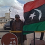 The flag of Libyan rebels hangs at this captured border post in Dhibat. Less than a week ago, the desert post was controlled by Gadhafi's  forces.