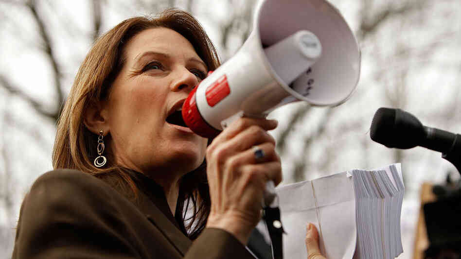 Rep. Michele Bachmann (R-MN), holding a stack of petitions, addresses a "Code Red" rally on Capitol Hill in March 2010, sponsored by The American Grassroots Coalition and the Tea Party Express. The rally was in opposition to the health care overhaul bill. Rep. Michele Bachmann (R-MN), holding a stack of petitions, addresses a "Code Red" rally on Capitol Hill in March 2010, sponsored by The American Grassroots Coalition and the Tea Party Express. The rally was in opposition to the health care overhaul bill.