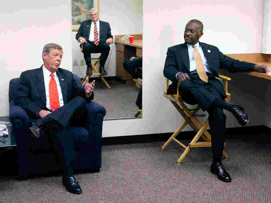Cain, Johnny Isakson (left) and Mac Collins (reflected in the mirror on the wall) wait before the start of a debate in Atlanta in 2004. The three were running for the U.S. Senate seat then held by Zell Miller.