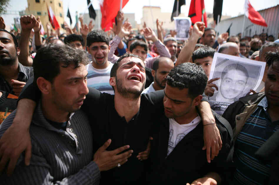 Friends and family members mourn during a funeral for slain anti-government protester Ali Ahmed al Muameen in February in Sitra, Bahrain. Friends and family members mourn during a funeral for slain anti-government protester Ali Ahmed al Muameen in February in Sitra, Bahrain.