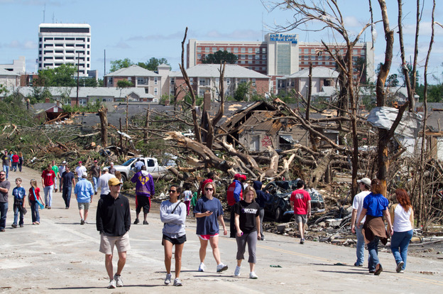 In the aftermath of a severe tornado, residents wander the steets near downtown Tuscaloosa surveying the damage.