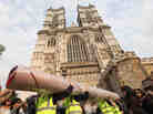 Workers carry in sections of the red carpet at Westminster Abbey where Prince William and Kate Middleton are scheduled to get married tomorrow.