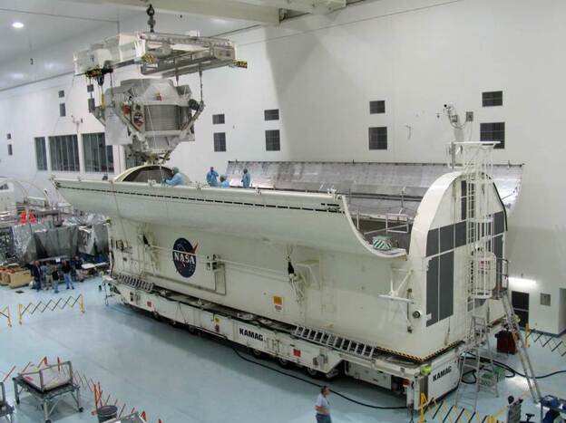 The Alpha Magnetic Spectrometer is loaded into the vehicle that would take it to the space shuttle launchpad on March 15. The $2 billion cosmic ray detector will be carried to the International Space Station on Endeavour's final flight.