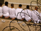 A group of detainees kneels during an early-morning Islamic prayer in their camp at the U.S. military prison for "enemy combatants" in 2009 in Guantanamo Bay, Cuba. A group of detainees kneels during an early-morning Islamic prayer in their camp at the U.S. military prison for "enemy combatants" in 2009 in Guantanamo Bay, Cuba.