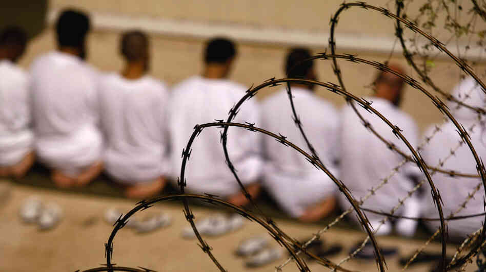 A group of detainees kneels during an early-morning Islamic prayer in their camp at the U.S. military prison for "enemy combatants" in 2009 in Guantanamo Bay, Cuba. A group of detainees kneels during an early-morning Islamic prayer in their camp at the U.S. military prison for "enemy combatants" in 2009 in Guantanamo Bay, Cuba.