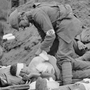 Soldiers care for the wounded on the first day of the Battle of Passchendaele on  July 31, 1917. Fought in West Flanders, Belgium, Passchendaele was one of the war's most costly clashes.