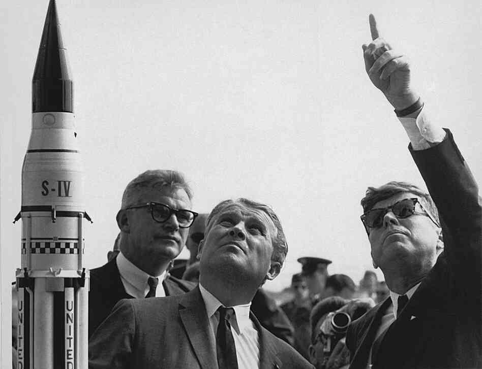 President John F. Kennedy gets a lesson on the Saturn launch system from Wernher von Braun (center), a German rocket scientist who championed America's space exploration program, during a visit to Cape Canaveral on Nov. 16, 1963. 