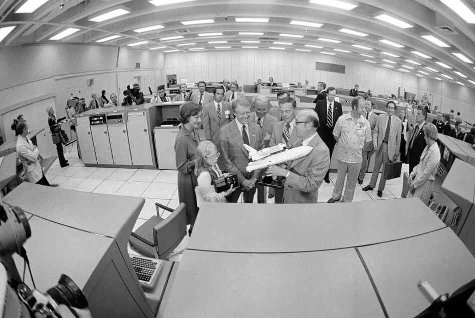 NASA Administrator Robert Froscoch (right) shows a model of the space shuttle to President Jimmy Carter, first lady Rosalynn Carter and daughter Amy during their visit to the firing room of the Launch Control Center at Cape Canaveral in October 1978. 