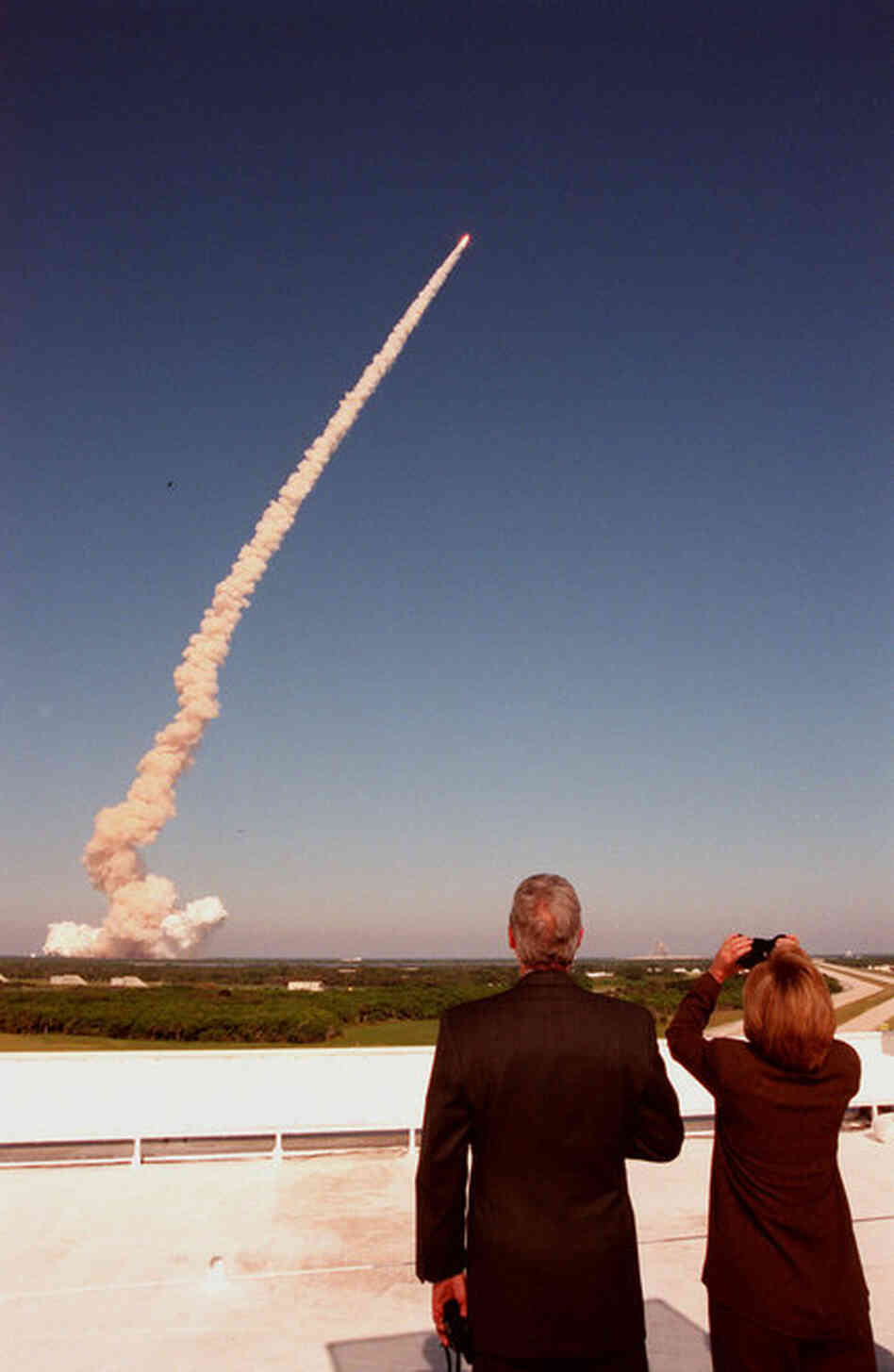 From the roof of the Launch Control Center, President Bill Clinton and Hillary Clinton watch the launch of space shuttle Discovery on Oct. 29, 1998. Astronaut and Sen. John Glenn was on the flight, his second to space. 